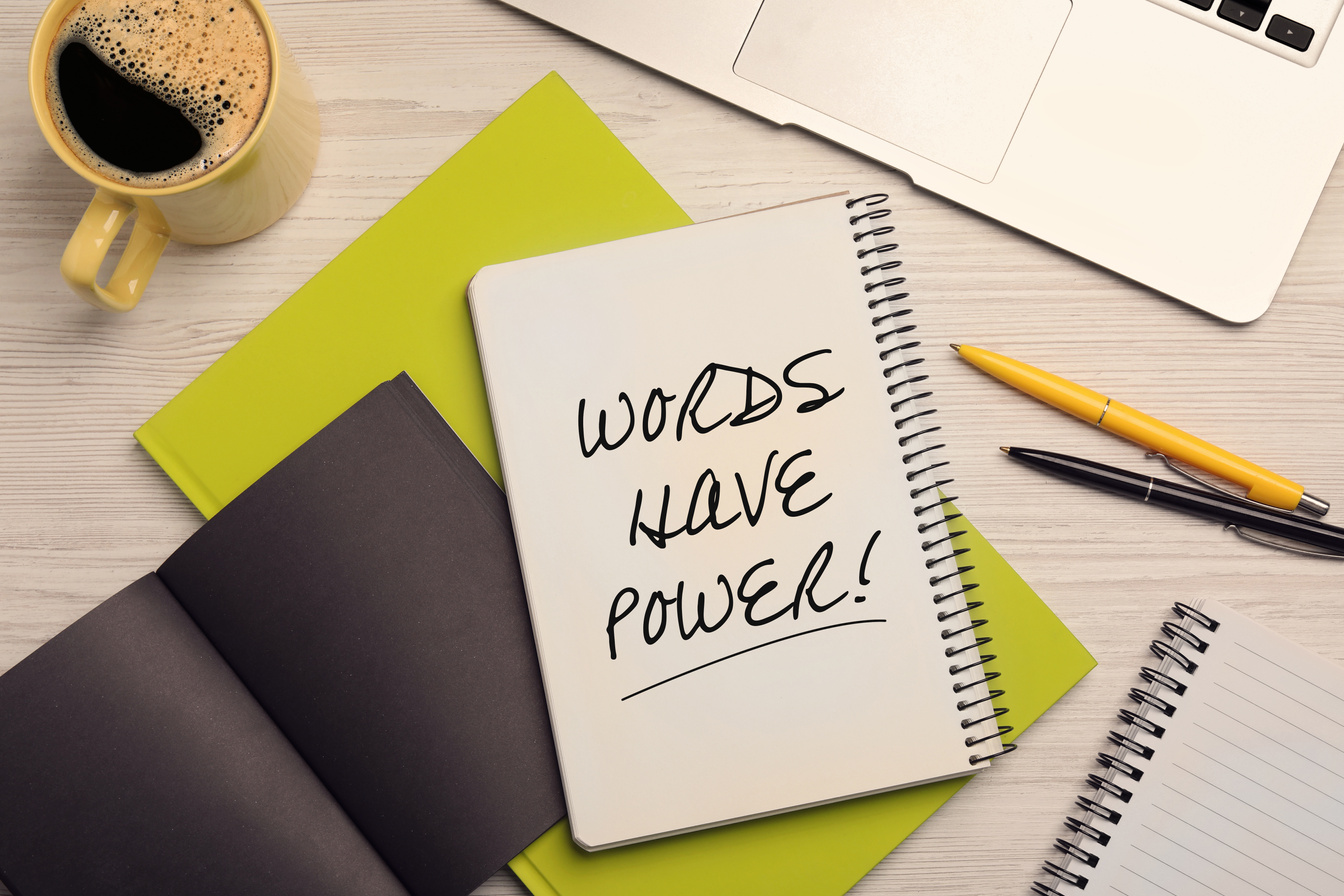Notebook with Phrase Words Have Power, Stationery, Coffee and Laptop on Light Wooden Table, Flat Lay